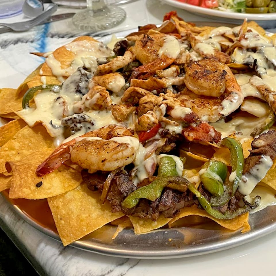 La Barra Del Taco's loaded nachos with shrimp, steak, chicken, peppers, and melted cheese.